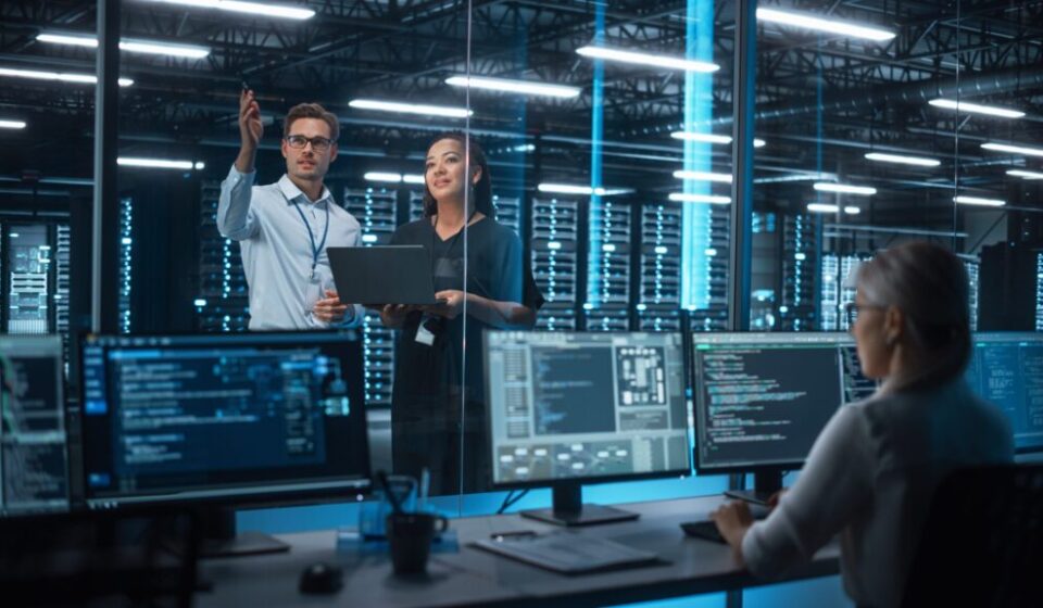 Team of DevOps engineers collaborating on a CI/CD pipeline and cloud infrastructure automation dashboard with code and deployment diagrams.