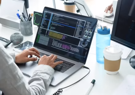 Team of dedicated developers working on a RESTful API integration with servers and code on screen