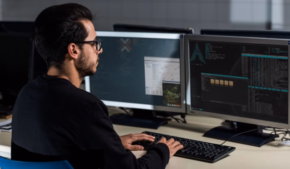A diverse team of software developers collaborating on a digital microservices architecture diagram, illustrating the need to hire Microservices Engineers for scalable tech startup growth.