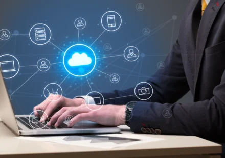A professional illustration featuring a hiring manager at a workstation reviewing candidate profiles on a digital dashboard, surrounded by cloud icons, server nodes, and a floating checklist. A glowing brain symbol represents strategic decision-making, while the overlaid text reads "What Hiring Managers Should Know About Cloud Recruitment." The image conveys the strategic approach required for successful Cloud Recruitment in today's competitive tech landscape.