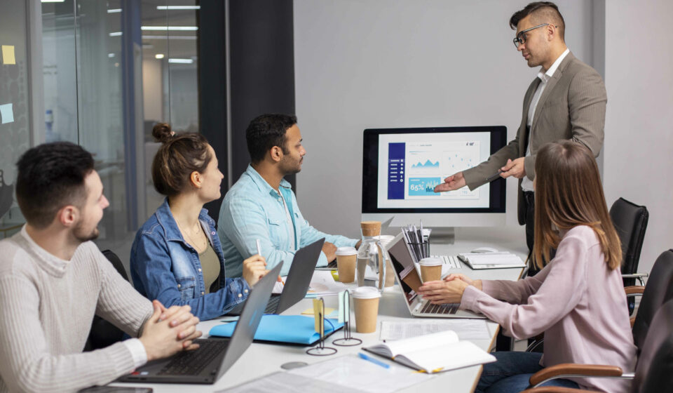 HR professionals and engineering managers collaborating with recruitment partners to scale tech teams in a modern office environment