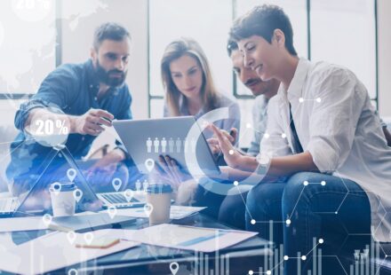 A professional illustration featuring the AWS logo at the center, surrounded by interconnected service icons representing compute, storage, networking, and machine learning capabilities. A team of silhouetted developers stands on a solid foundation built from AWS infrastructure, with upward-trending arrows, shields, and gears symbolizing scalability, security, and operational excellence. Overlaid text reads "How AWS Expertise Can Strengthen Your Technology Team." The image represents the transformative power of AWS Expertise in building resilient, high-performing engineering organizations.