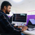 Engineering manager pairing developer profiles with programming languages and frameworks on a digital matrix, selecting the Right Technology Stack for each role
