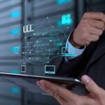 Recruiter and engineering lead reviewing resumes and container architecture diagrams to hire engineers for Containerized Applications