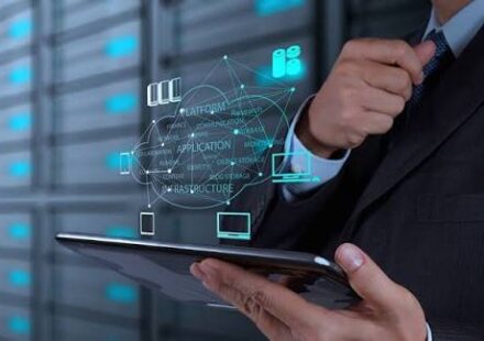 Recruiter and engineering lead reviewing resumes and container architecture diagrams to hire engineers for Containerized Applications