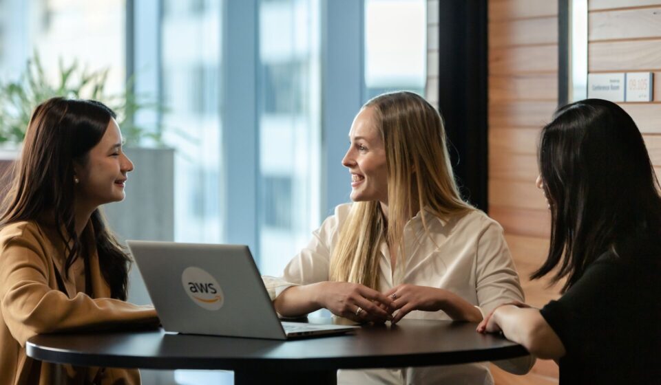 Recruiter and cloud architect reviewing AWS infrastructure diagrams and candidate profiles, highlighting best practices for Hiring AWS talent