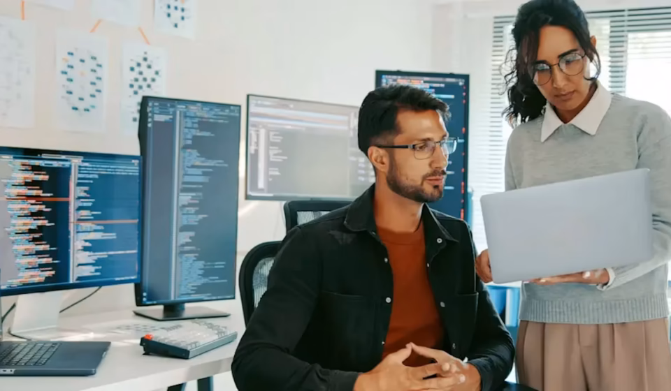 Software engineers collaborating around containerized application diagrams, showcasing how Docker Skills integrate into modern DevOps Engineer Skills