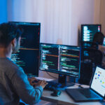 Microservices Developer reviewing a distributed system architecture with API gateways and containers, highlighting key DevOps Engineer Skills